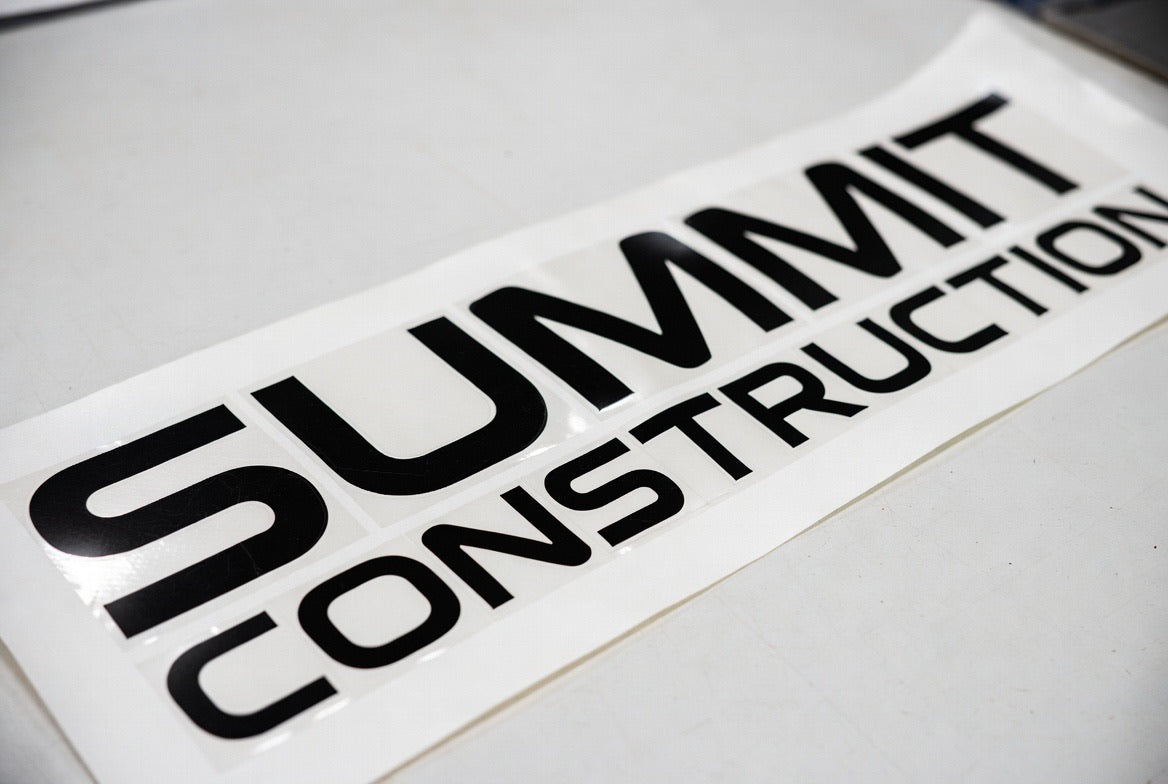 Summit Construction lettering – black vinyl on flat surface