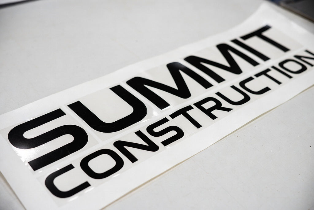 Summit Construction lettering – black vinyl on flat surface