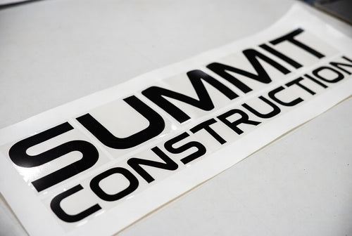 Summit Construction lettering – black vinyl on flat surface