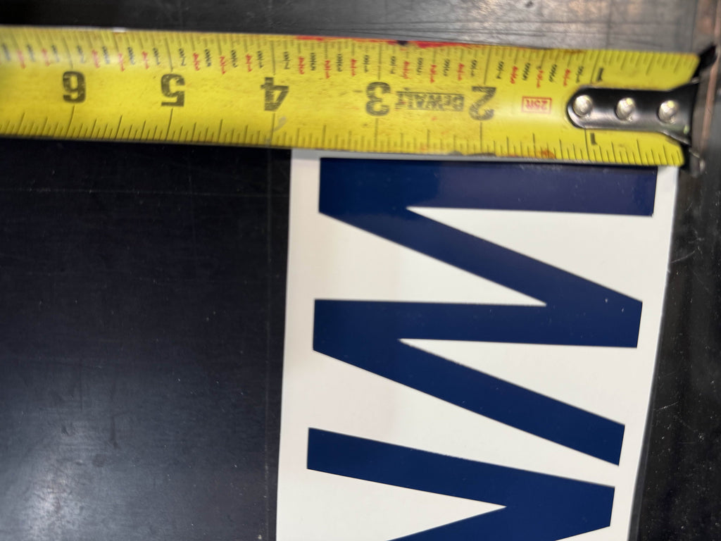 Boat registration numbers measured against a tape - 3 inch cap height, USCG legal