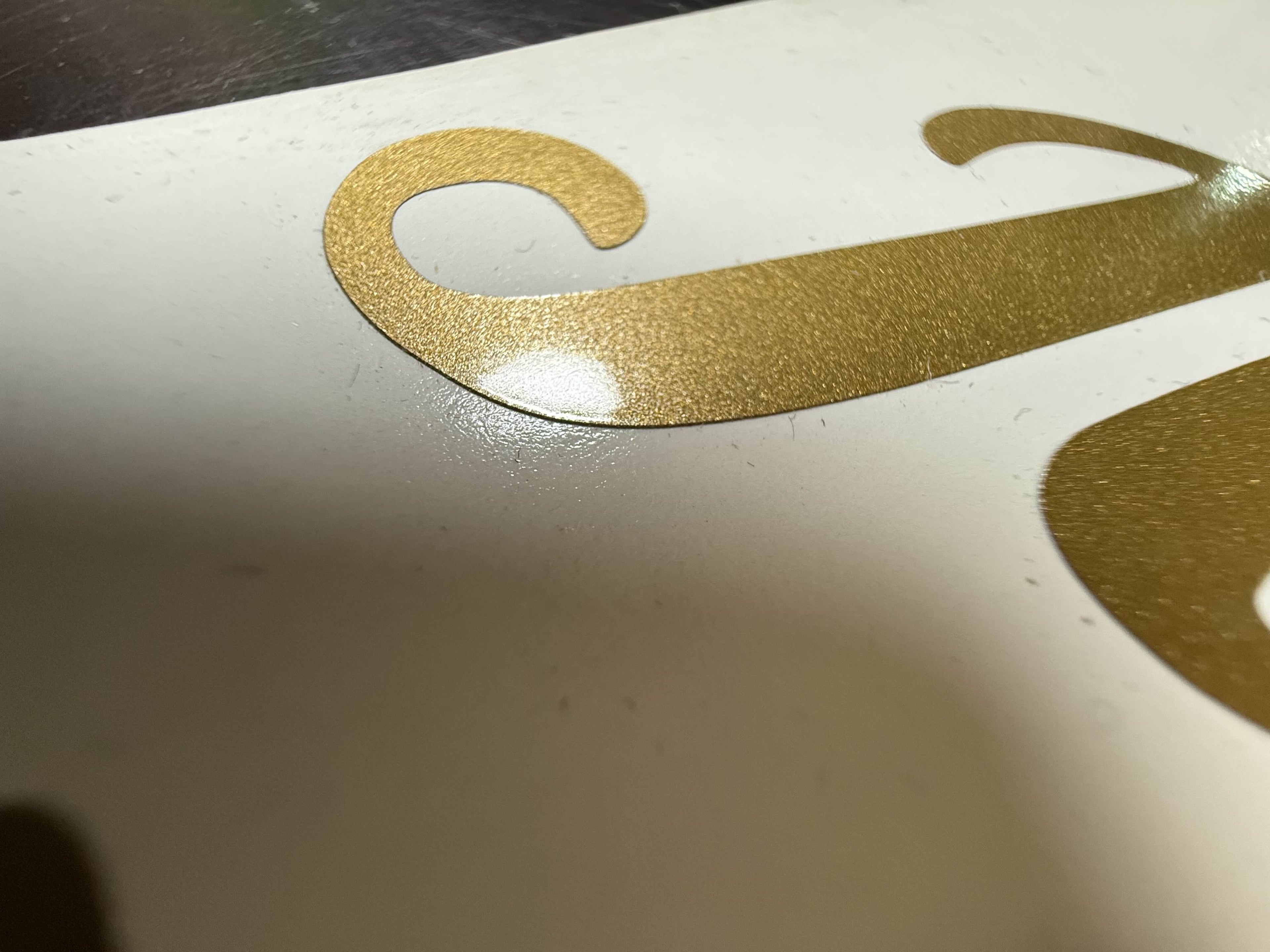 Custom script logo cut in gold metallic vinyl - layout and design work by JZAC Designs