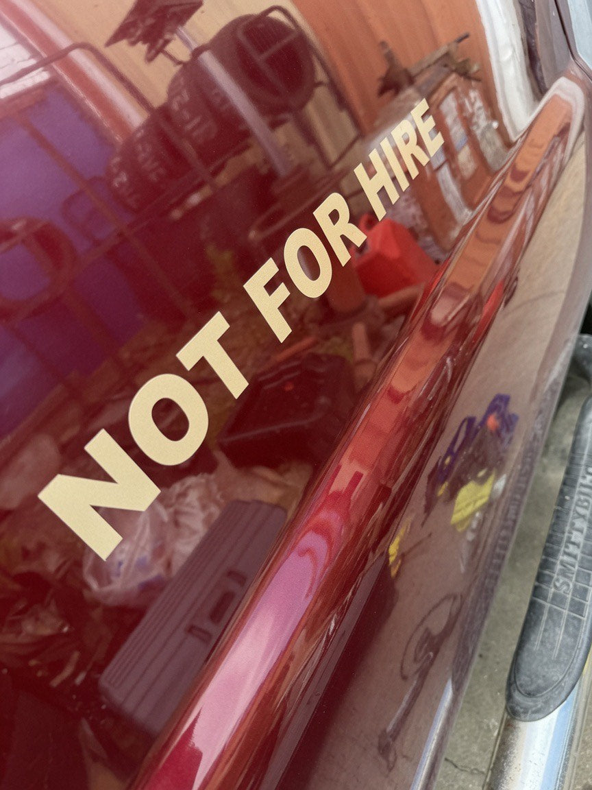 NOT FOR HIRE gold vinyl lettering installed on a maroon truck door - 3M commercial cast vinyl by JZAC Designs