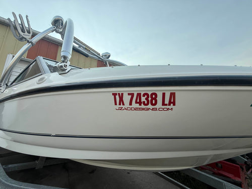 Red vinyl lettering applied to a boat hull side, clean edges and even spacing