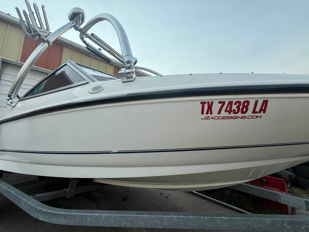 Boat lettering on a white hull, angled view showing full layout