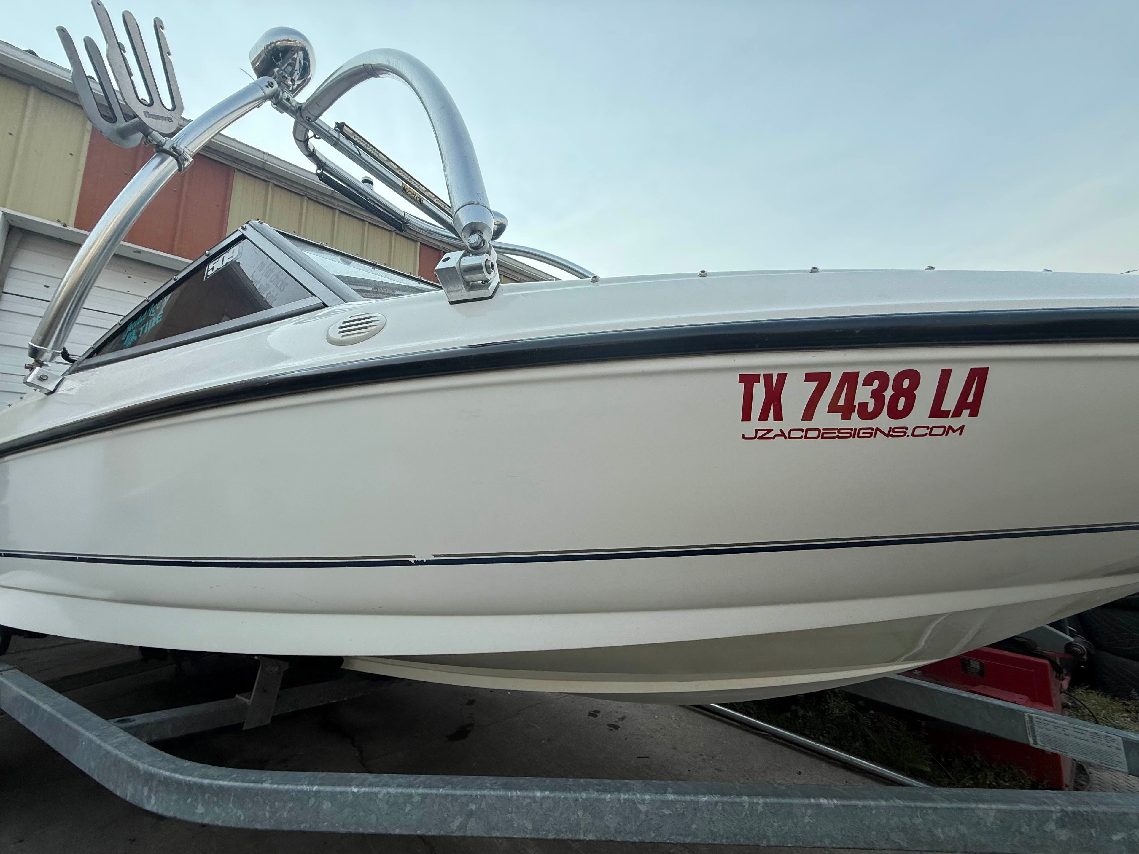 Boat lettering on a white hull, angled view showing full layout