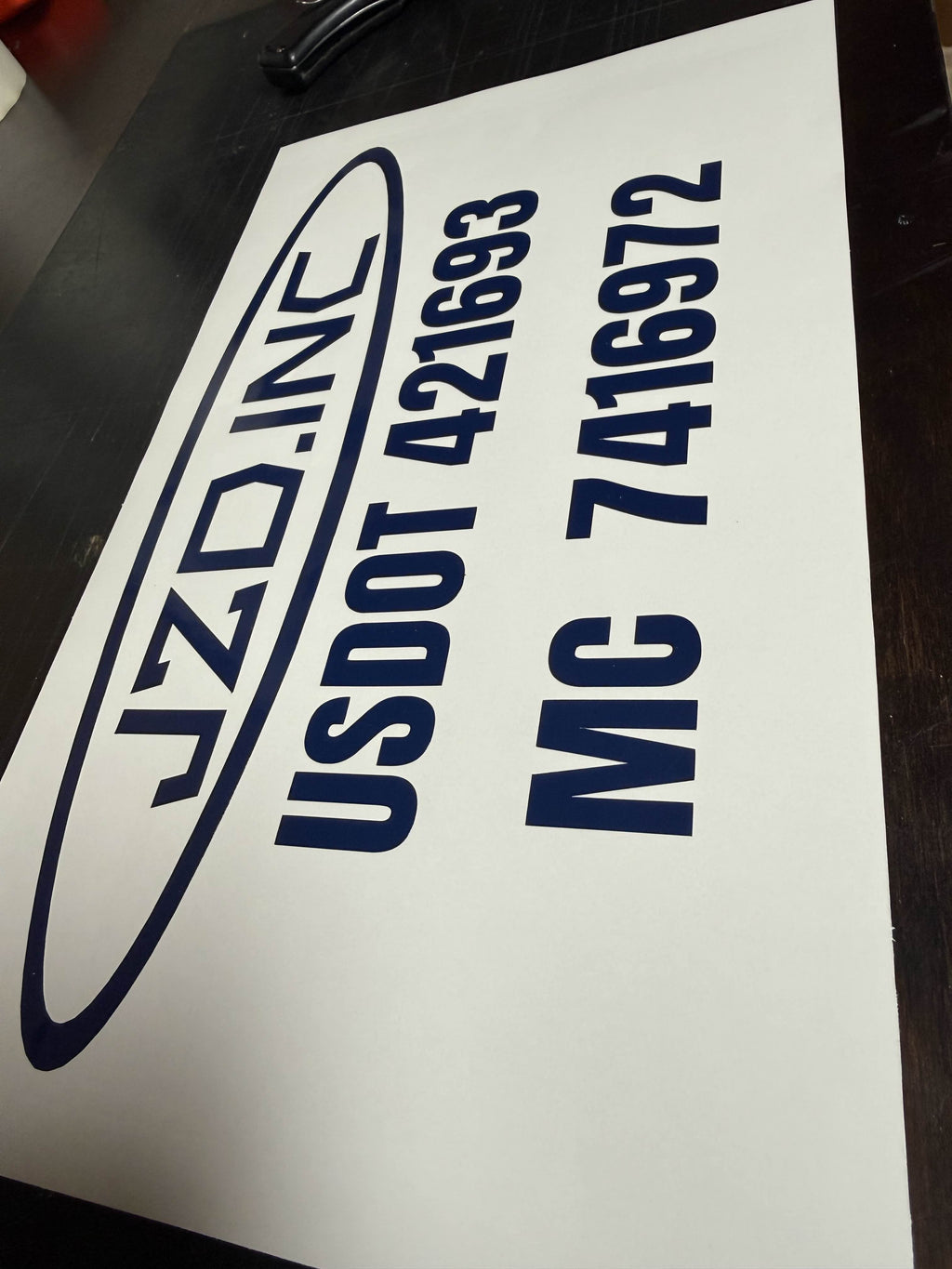 Fleet truck door with company and DOT compliance lettering