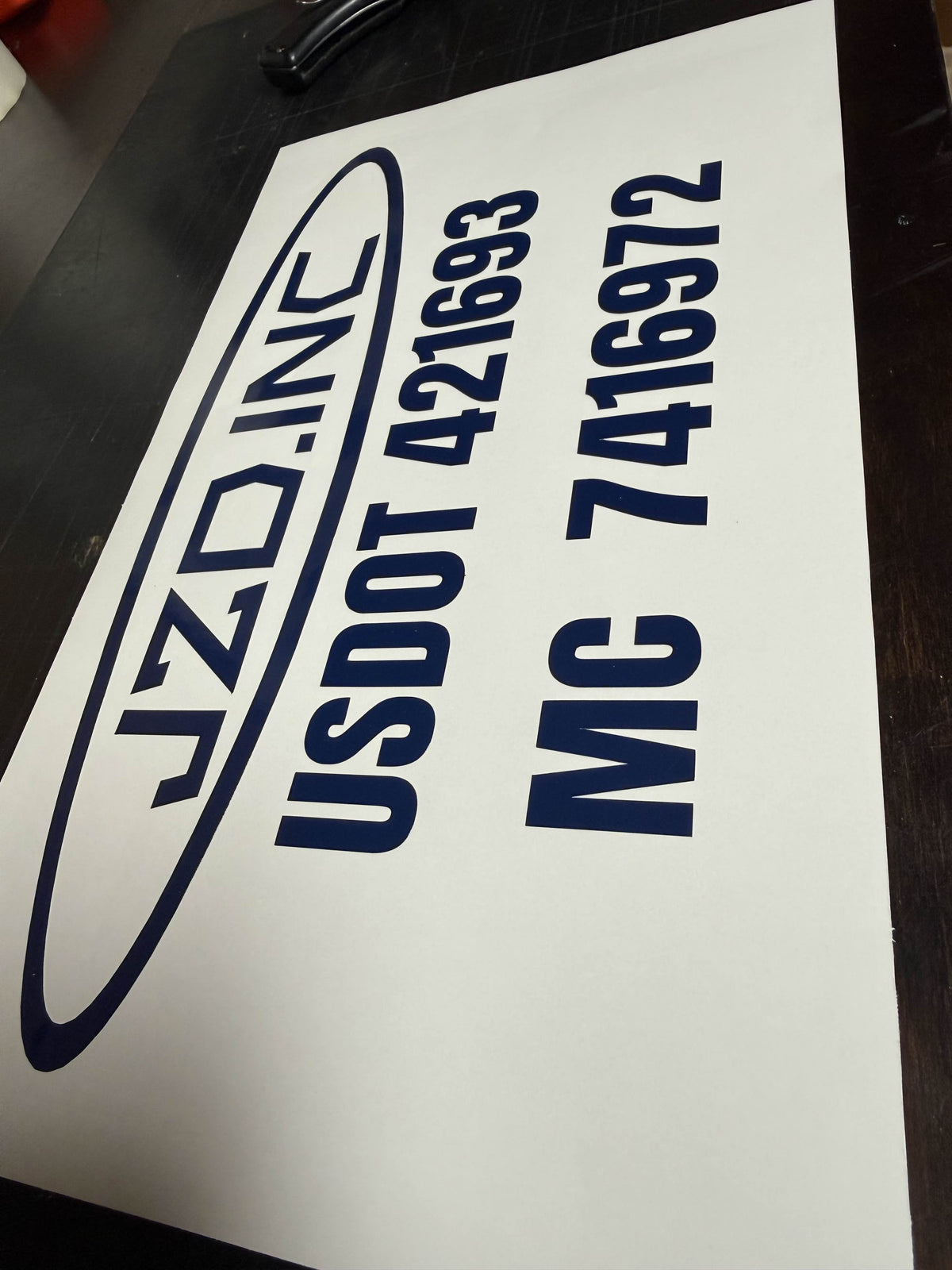 Fleet truck door with company and DOT compliance lettering