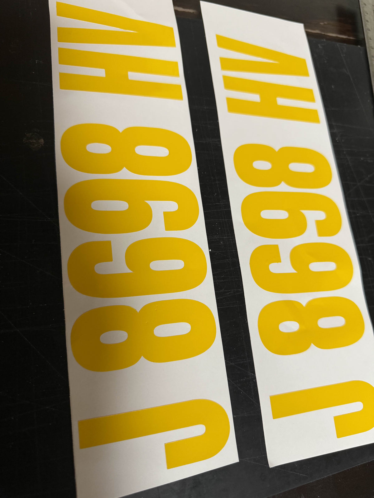 Boat registration number lettering installed on a hull