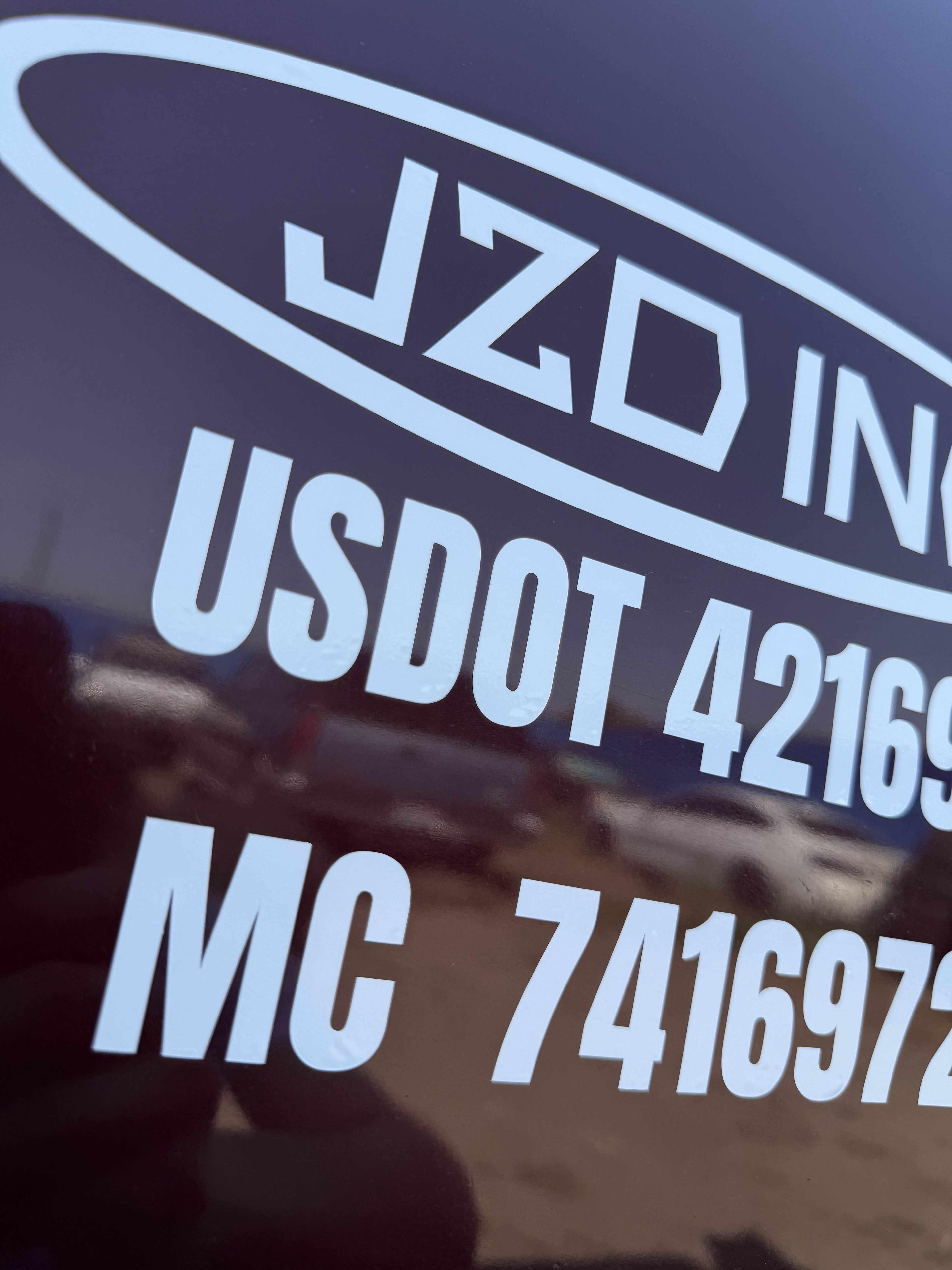 Fleet DOT lettering - company name, USDOT and MC numbers applied to a truck door