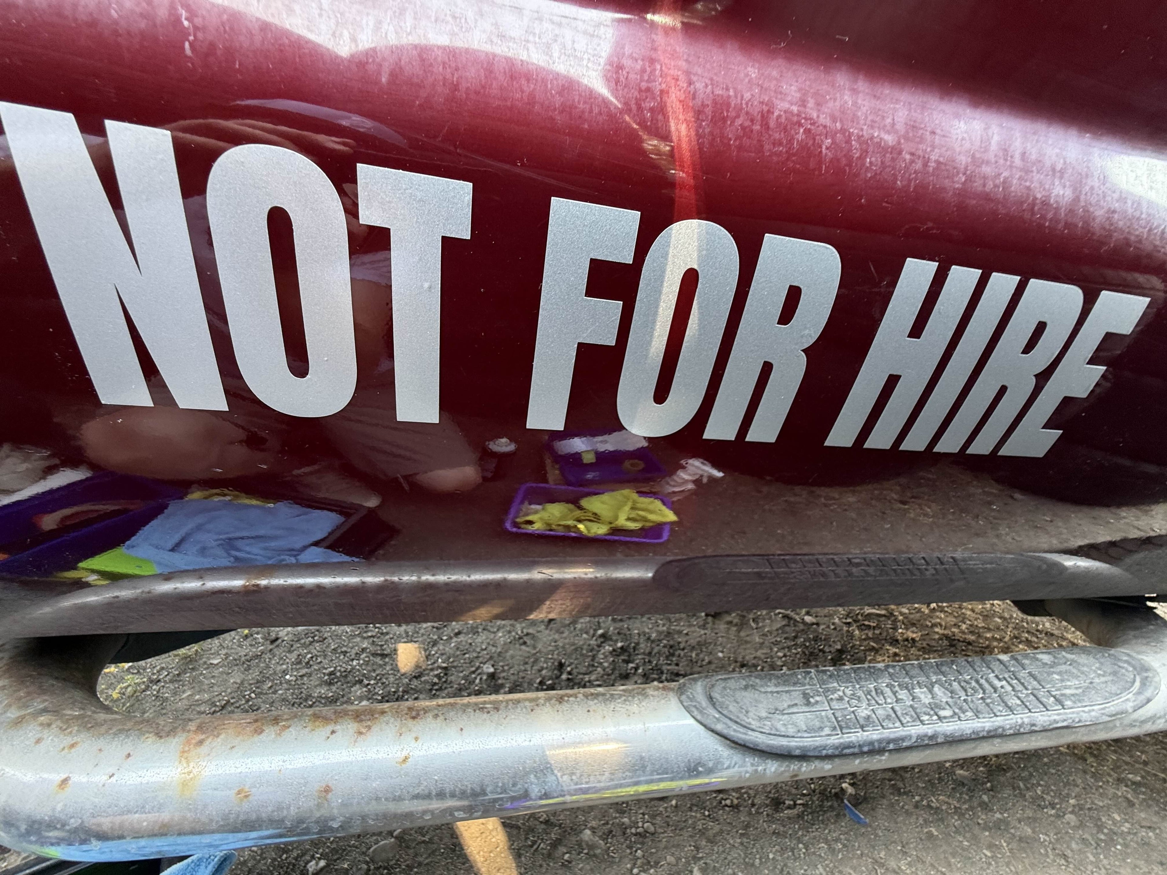 NOT FOR HIRE decal applied to a maroon truck panel - DOT sized lettering