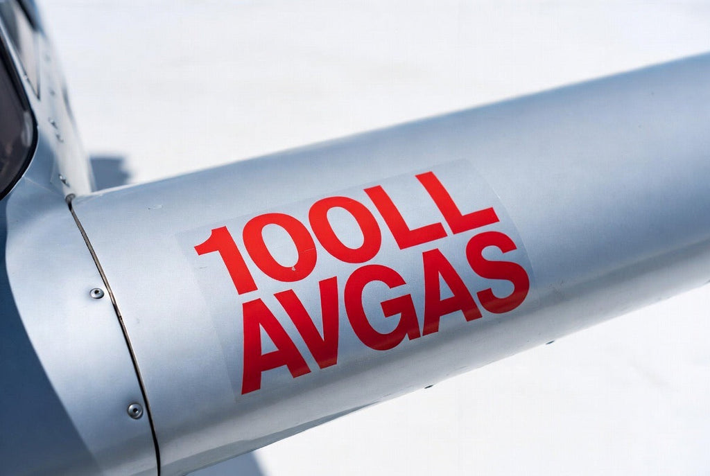 100LL AVGAS fuel placard applied to a polished aircraft cowl