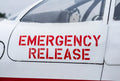 On-airport install - EMERGENCY RELEASE placard applied to an aircraft cockpit door