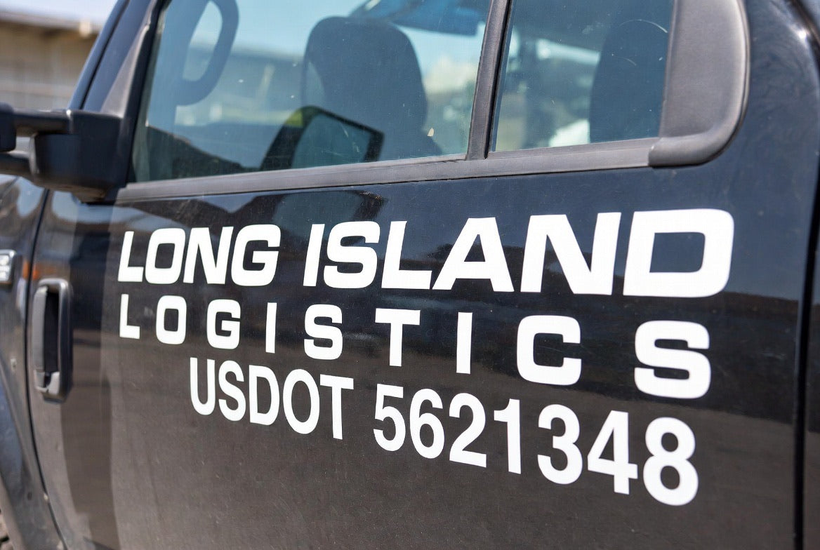 White company name and USDOT number lettering on a black truck door - fleet DOT lettering by JZac Designs