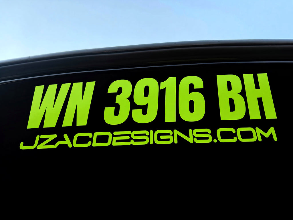 Bright green WN 3916 BH registration lettering and JZACDESIGNS.COM on a black surface