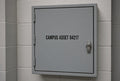 Illustration of CAMPUS ASSET 04217 cut-vinyl asset numbering on a campus equipment enclosure