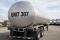 Illustration of UNIT 307 cut-vinyl identification on a stainless cargo tank trailer