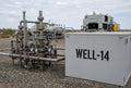 Illustration of WELL-14 cut-vinyl site identification on a wellhead control building