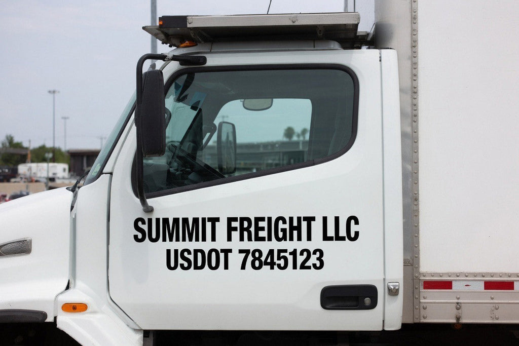 USDOT number decal installed on a truck door in white cut vinyl